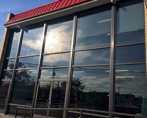 A glass storefront with aluminum frames